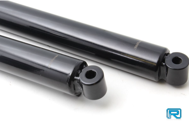 Two black shock absorbers on a white background