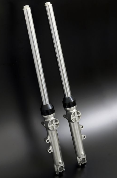 Pair of metallic shock absorbers on a dark background