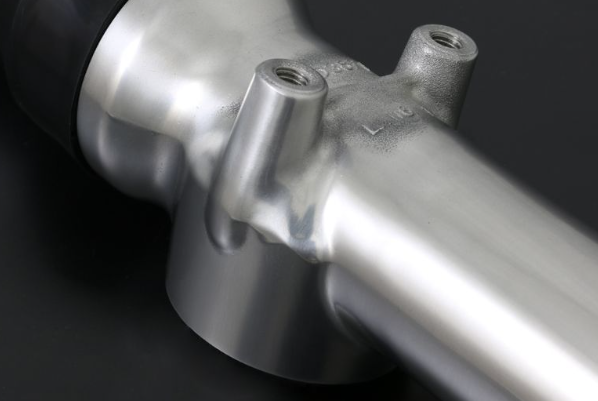 Close-up of a metallic bicycle frame on a dark background