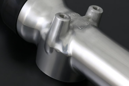Close-up of a metallic bicycle frame on a dark background