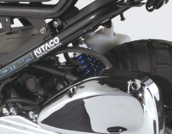 Close-up of a motorcycle with Kitaco branding on a white background