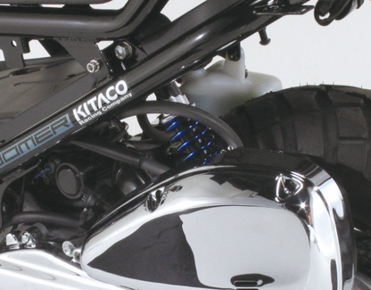 Close-up of a motorcycle with Kitaco branding on a white background