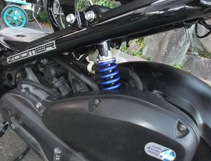 Close-up of a motorcycle suspension system with 'Zumler' branding.