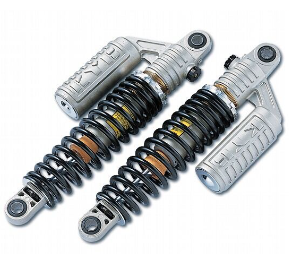 Two motorcycle shock absorbers on a white background
