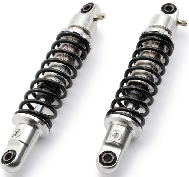 Two motorcycle shock absorbers on a white background