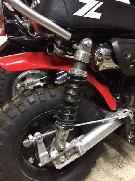 Close-up of a motorcycle's suspension system with visible branding.