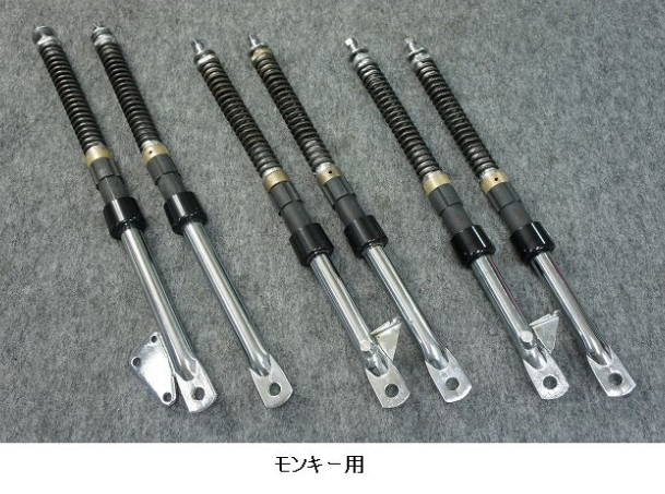 Set of six shock absorbers on a gray background