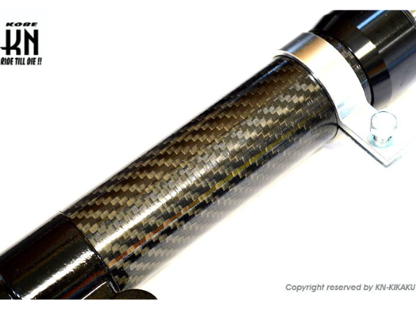Carbon fiber grip with metallic accents on a white background, featuring KOKI branding.