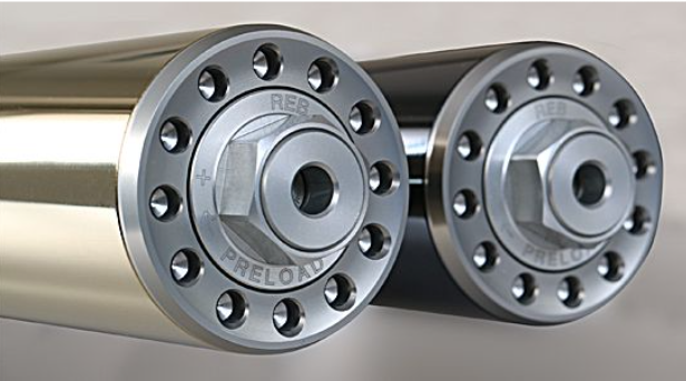 Two metal cylindrical components with flanges on a gray background