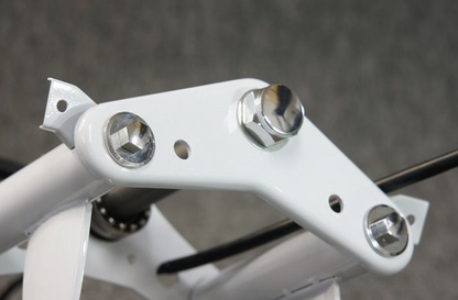 Close-up of a white metal bracket with screws on a blurred background