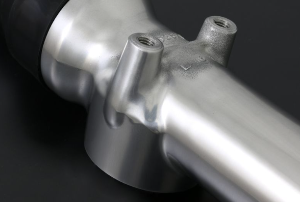 Close-up of a metallic bicycle frame on a dark background