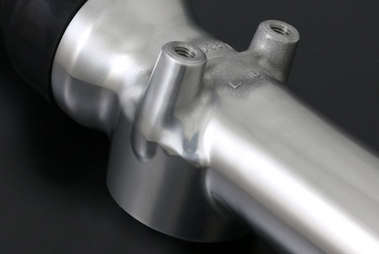 Close-up of a metallic bicycle frame on a dark background