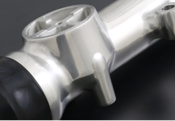 Close-up of a metallic motorcycle handlebar on a dark background