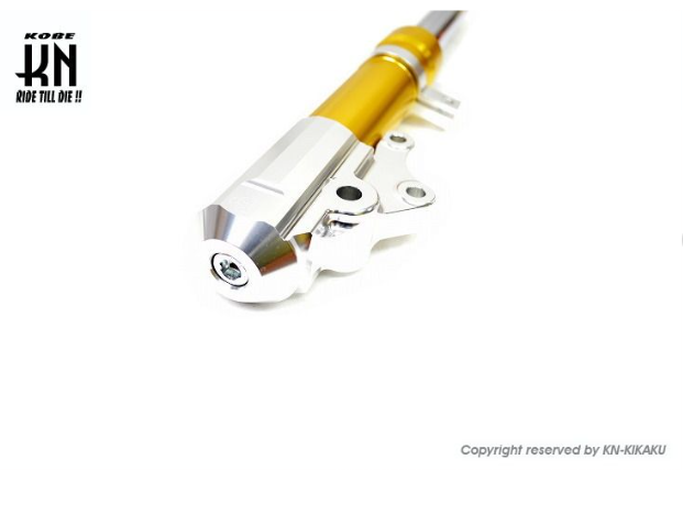 Motorcycle suspension fork with gold and silver finish on a white background, featuring KORE branding.