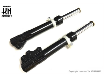 Two black motorcycle shock absorbers on a white background with 'Kobe' branding.