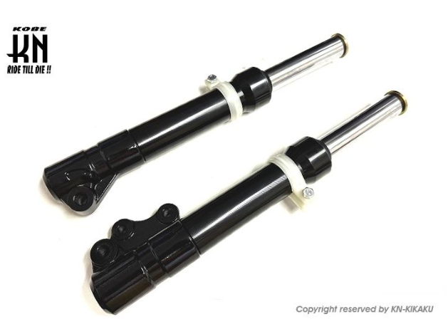 Two black motorcycle shock absorbers on a white background with 'Kobe' branding.