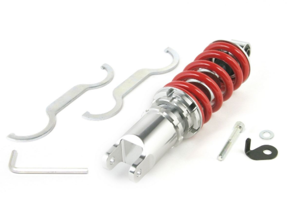 Car suspension shock absorber with red coil spring on a white background