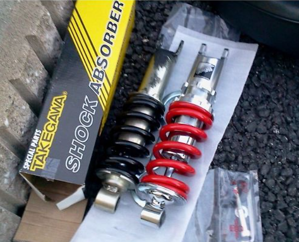 Takegawa shock absorber with packaging on a textured surface