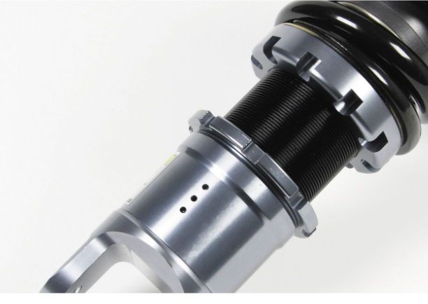 Close-up of a suspension shock absorber on a white background