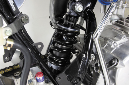 Close-up of a motorcycle suspension system with visible branding.