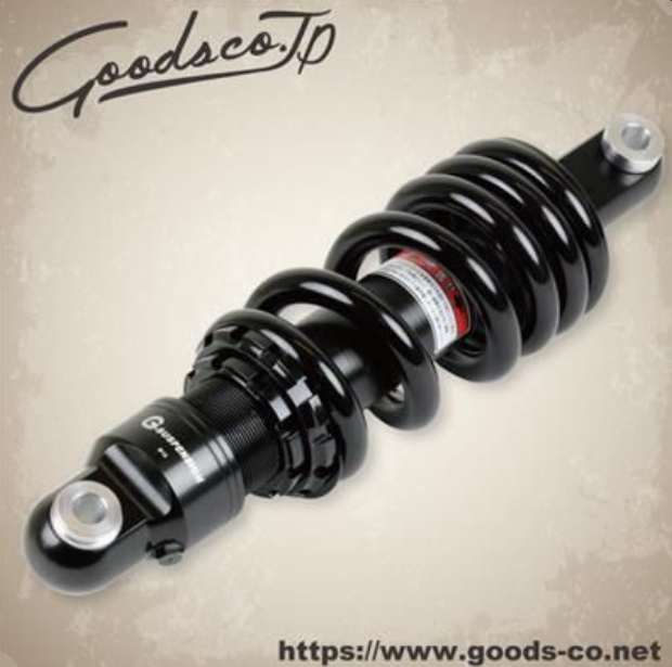 Black shock absorber with visible branding on a beige background