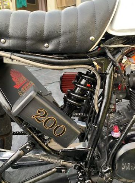 Close-up of a motorcycle with '200' on the side, featuring Honda branding.