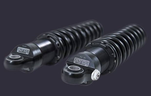 Two black shock absorbers with 'Savage' branding on a dark background
