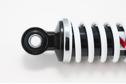 Close-up of a black and white shock absorber on a white background