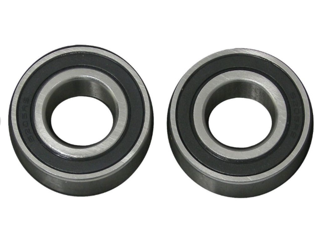 Two black metal bearings on a white background