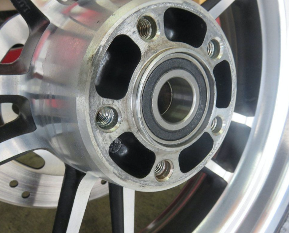 Close-up of a metallic wheel hub with bolts