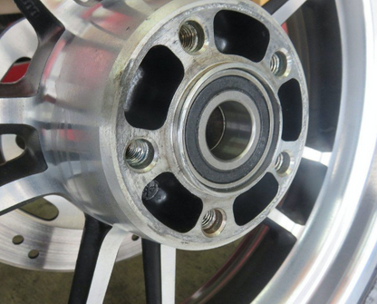 Close-up of a metallic wheel hub with bolts