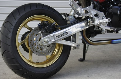 Close-up of a motorcycle wheel with a visible brand name on the suspension.