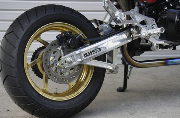 Close-up of a motorcycle wheel with a visible brand name on the suspension.