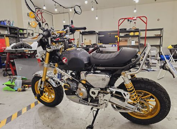 Motorcycle in a workshop with tools and equipment in the background