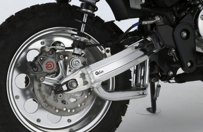 Close-up of a motorcycle wheel and suspension system on a white background