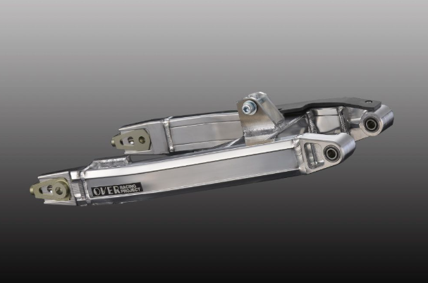 Metallic car suspension component on a gray background