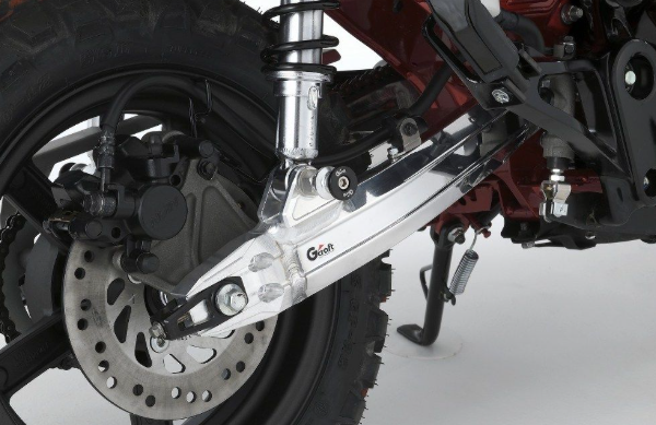 Close-up of a motorcycle's wheel and suspension system on a white background
