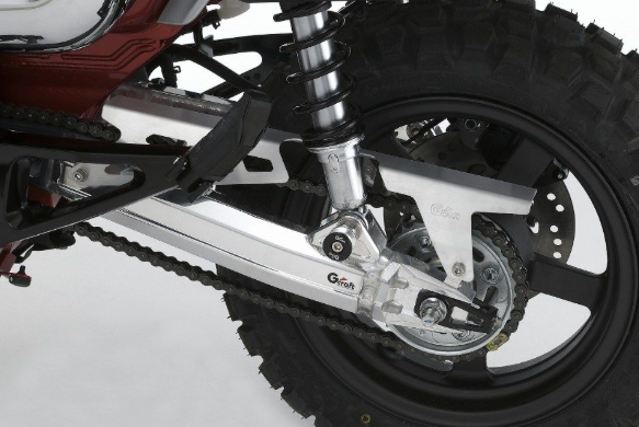Close-up of a motorcycle chain and sprocket on a white background