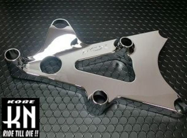 Chrome motorcycle part on a textured black background with Kobe KN branding.