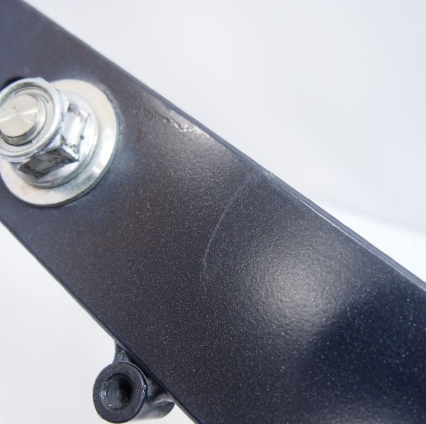 Close-up of a skateboard truck with a silver bushing on a white background
