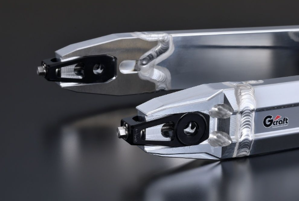 Metallic tool with 'Graft' branding on a reflective surface