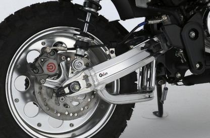 Close-up of a motorcycle wheel and suspension system on a white background