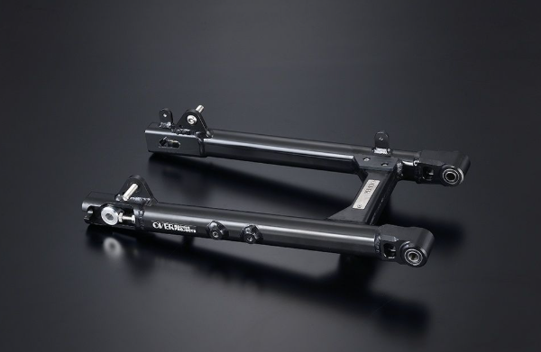 Two black metal components on a dark background
