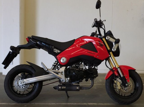Red motorcycle with black seat on a plain background