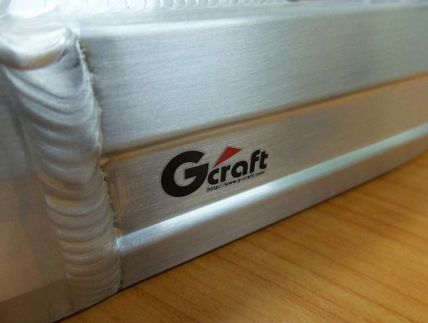 White mattress corner with 'Gcraft' logo on a wooden floor