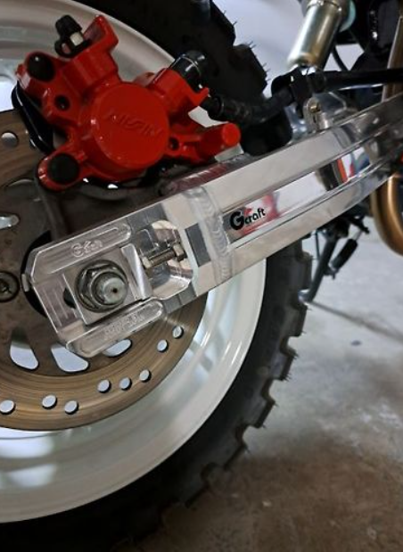 Close-up of a motorcycle brake system with red caliper and 'Giro' branding.