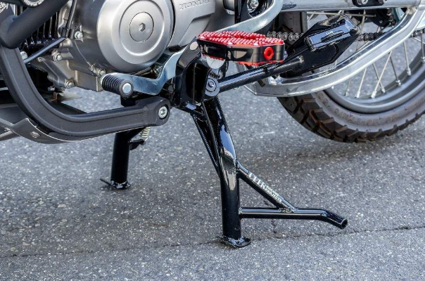 Motorcycle kickstand on a motorcycle with a close-up view of the mechanism.