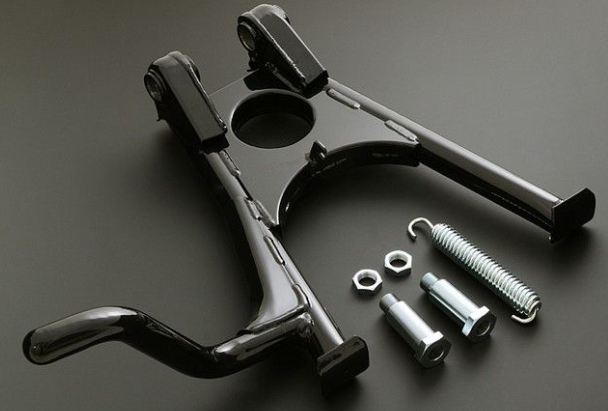 Metal mechanical component with bolts and springs on a dark background