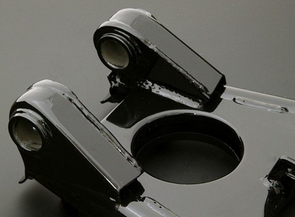 Close-up of a metallic object with a reflective surface on a gray background