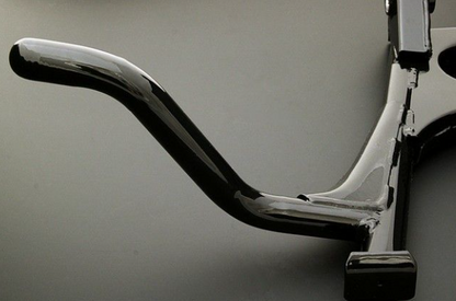 Close-up of a motorcycle foot peg and brake lever on a gray background